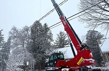 A telehandler machine near a hydro line